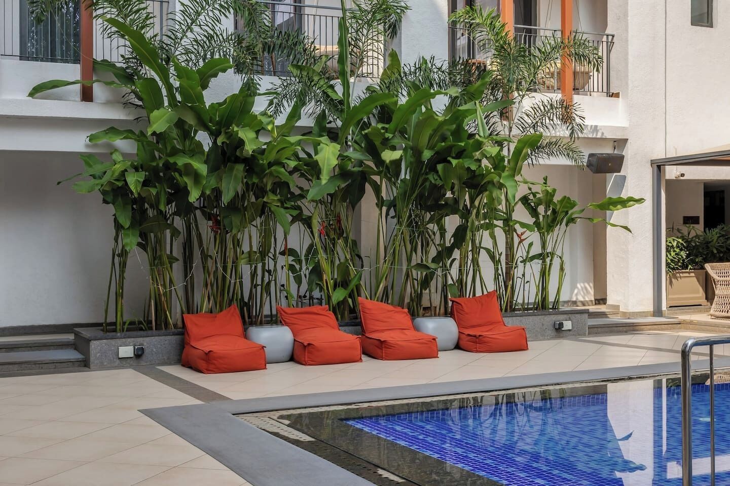 A poolside area with a seating arrangement and a pool.