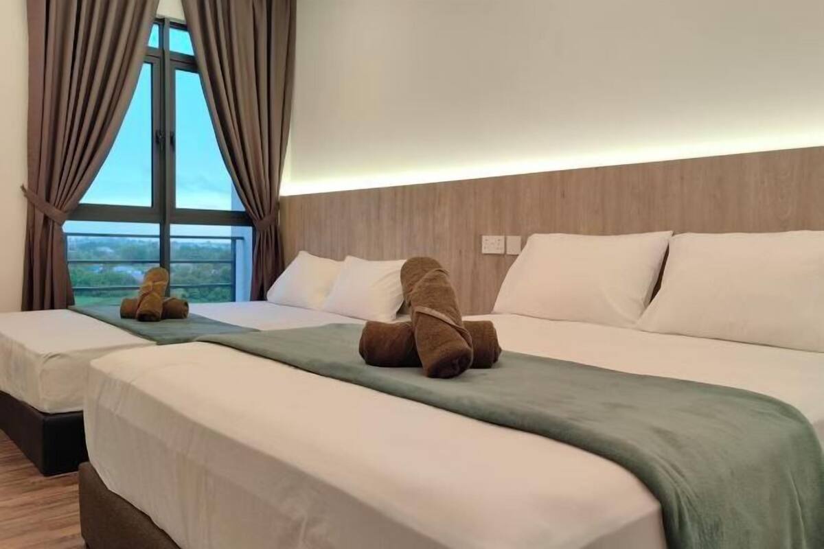A hotel room with two beds, a large window with curtains, and a view of the outdoors.