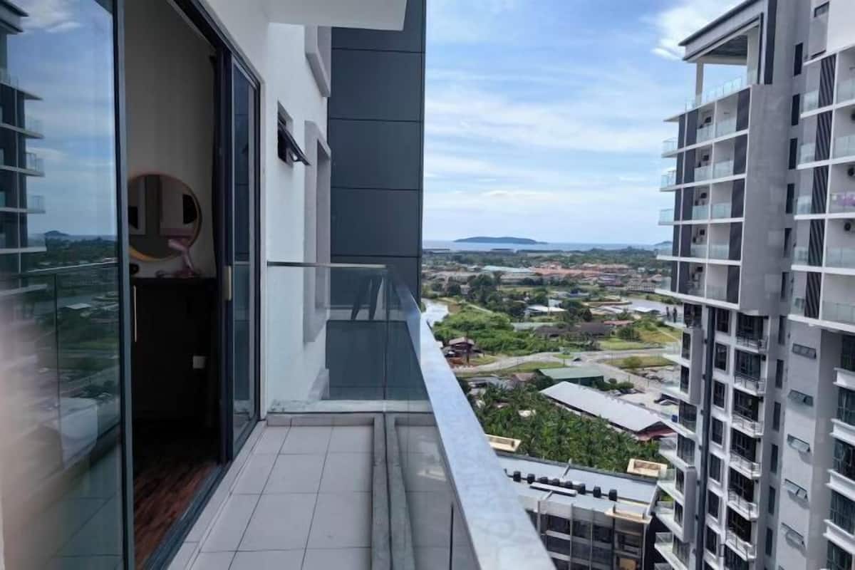 A modern building with a balcony overlooking a cityscape.