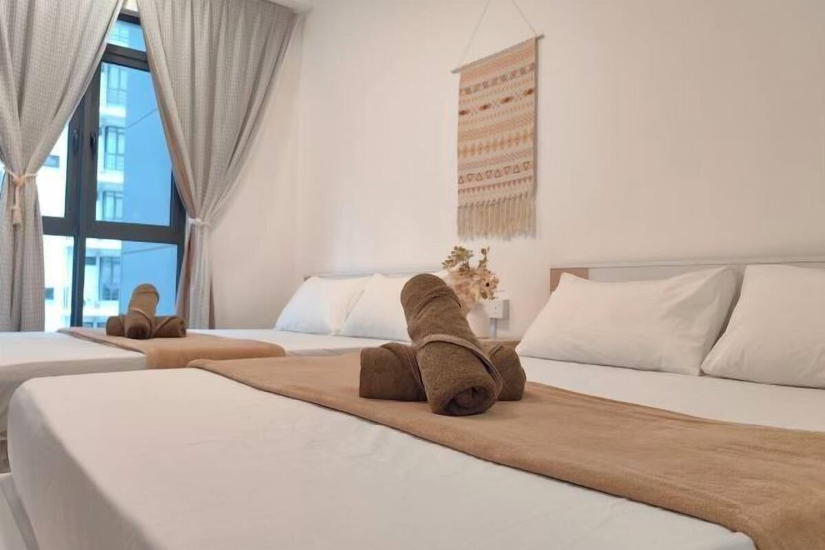 A hotel room with two beds, a large window, and a wall-mounted tapestry.