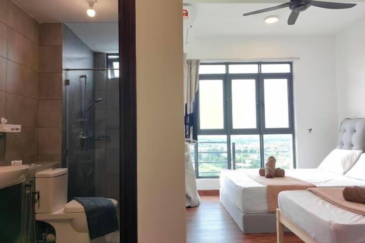 A modern bathroom with a glass shower enclosure, a toilet, and a sink.