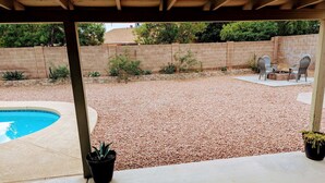 A covered patio area with a pool, a fire pit, and outdoor seating. - Ahwatukee Home-Mountain Views, Large Pool, Hiking, Peaceful, Clean & Comfortable (Phoenix)