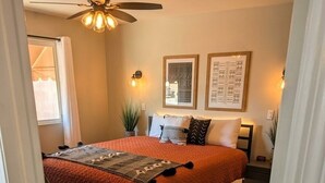 A bedroom with a double bed, a ceiling fan, and framed artwork on the wall. - Ahwatukee Home-Mountain Views, Large Pool, Hiking, Peaceful, Clean & Comfortable (Phoenix)