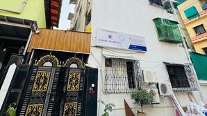A multi-story building with a sign for RAKSHAI RESIDENCY. - Hotel Raksha Residency (Navi Mumbai)