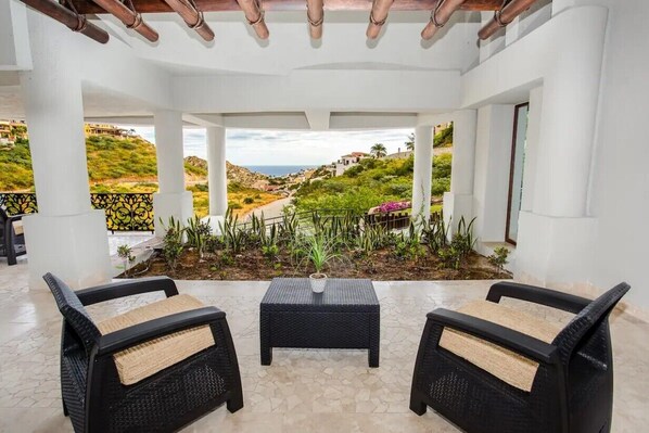 Relax in a serene hillside setting with a seating area featuring two comfortable chairs and a small table.