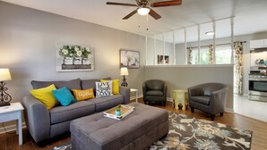 A modern living room with a grey sofa, two armchairs, a coffee table, and a ceiling fan. - "Broken Arrow 3-Bedroom Retreat – Cozy, Family-Friendly with WiFi & AC!" (Broken Arrow)