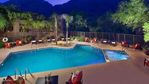 A swimming pool with lounge chairs and a view of mountains. - Views of Ventana Canyon Golf course and Desert Sunsets!   (Tucson)