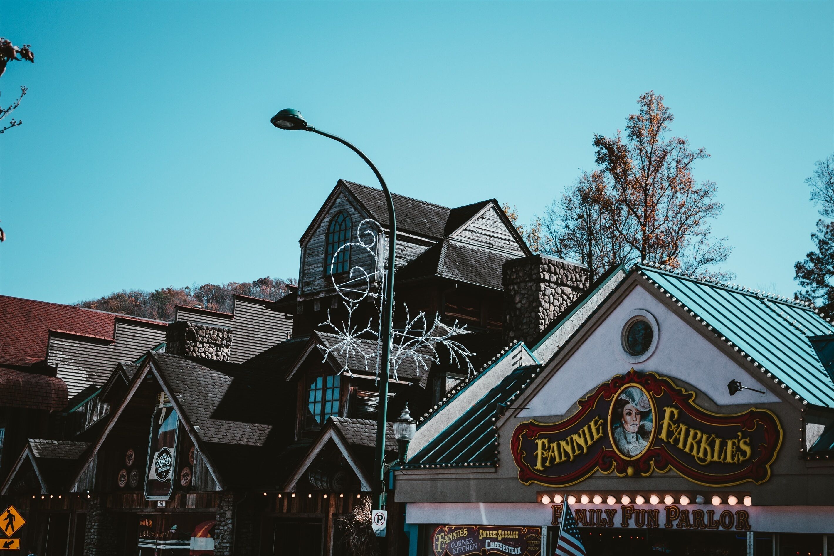 A building with a sign for 'Fanny's Family Fun Parlor' and a large beer bottle advertisement.