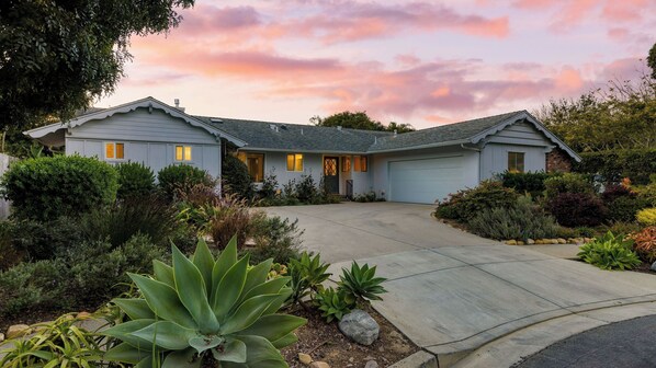 A two-story house with a garage, surrounded by landscaped gardens and a driveway. - Goleta Getaway by Avantstay Private Backyard, 1.5mi to the Beach! (Goleta)