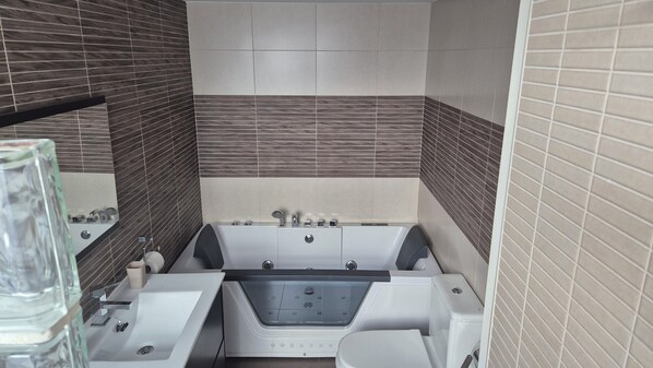 A modern bathroom with a bathtub, two sinks, and a glass shower enclosure. - In the center of town, Edif. Penibética, Bulevar de la Cala de Mijas, (La Cala de Mijas)