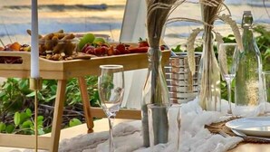 A table set for a meal with a view of the sunset.