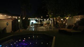 An outdoor pool area with a bar and seating.