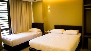 A hotel room with two beds, a ceiling fan, a nightstand with a phone, and a window with curtains. - Golden Leaf Boutique Hotel (Johor Bahru)