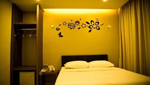 A hotel room with a bed, a nightstand, a telephone, and a wardrobe. - Golden Leaf Boutique Hotel (Johor Bahru)