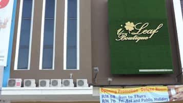 A hotel with a large sign for a boutique named 'Leaf Boutique Hotel.'
