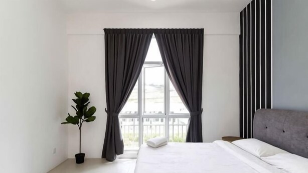 A bedroom with a bed, curtains, a plant, and a view through the window. - DreamScape Apartment @ Golden Hill (Brinchang)