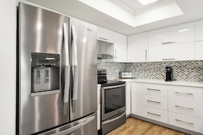 A modern kitchen with stainless steel appliances, a toaster, and a coffee maker.