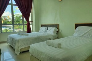 A hotel room with two beds, a large window with curtains, and a view of greenery outside. - Hotel O Good View Inn (Sri Aman)