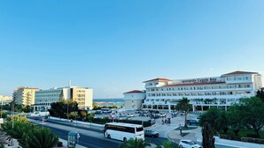 A multi-story hotel with a prominent sign reading "Leonardo Cypria Bay".