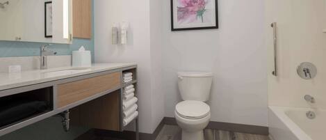 A modern bathroom with a toilet, sink, and bathtub.