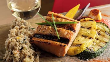 A meal with grilled salmon, grilled vegetables, and quinoa.