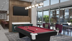 A pool table with balls, a bar area, and a large TV screen. - Homewood Suites By Hilton Columbia Downtown (Columbia)