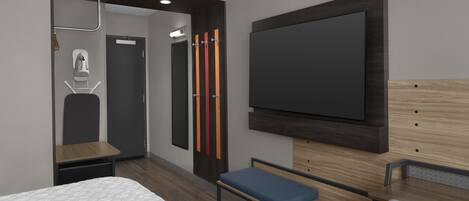 Een moderne hotelkamer met een bed, bureau, bankje, een aan de muur bevestigde televisie en een garderobe met spiegel.