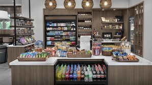 A modern retail space with shelves stocked with beverages, snacks, and other items. - Tru By Hilton Columbia Downtown (Columbia)