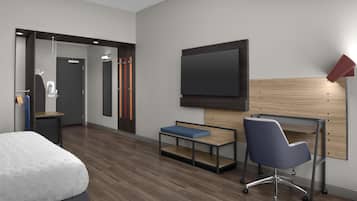 Una habitación de hotel moderna con cama, escritorio con silla, televisor montado en la pared y zona de ducha.