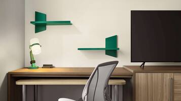 A modern office desk with a chair, a desk lamp, and two green wall-mounted shelves.