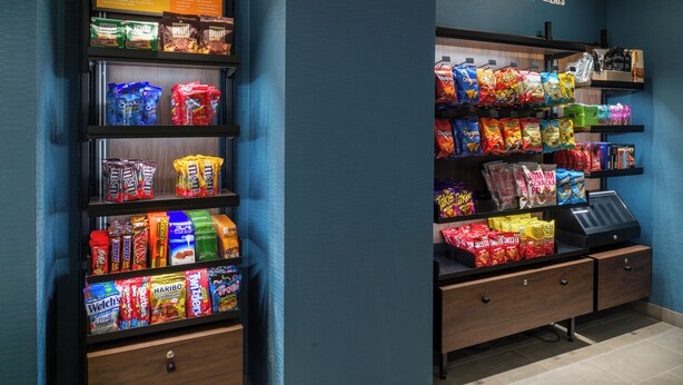 A snack vending machine with various snack options. - Hampton Inn By Hilton St Louis Airport (St. Louis)