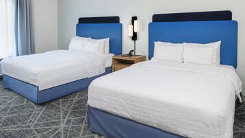 Premium bedding, desk, laptop workspace, blackout drapes