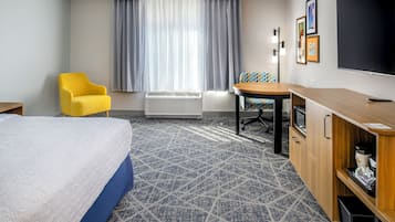 Premium bedding, desk, laptop workspace, blackout drapes