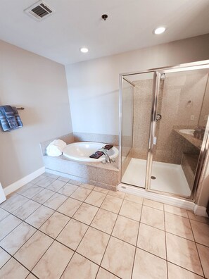 A bathroom with a glass-enclosed shower, a freestanding bathtub, and a towel rack. - Exceptional unit! Extra large offering the best set up and views! (Panama City Beach)