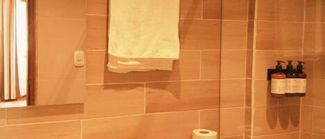 A bathroom with a toilet, sink, and shower.