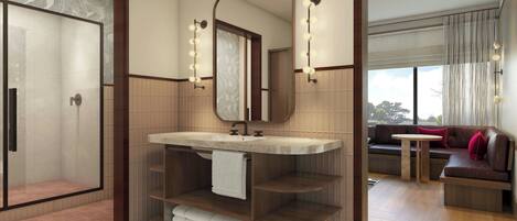 A modern bathroom with a shower, vanity, and seating area.