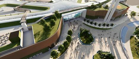 A modern architectural complex with a central open plaza, surrounding buildings, and landscaped areas.