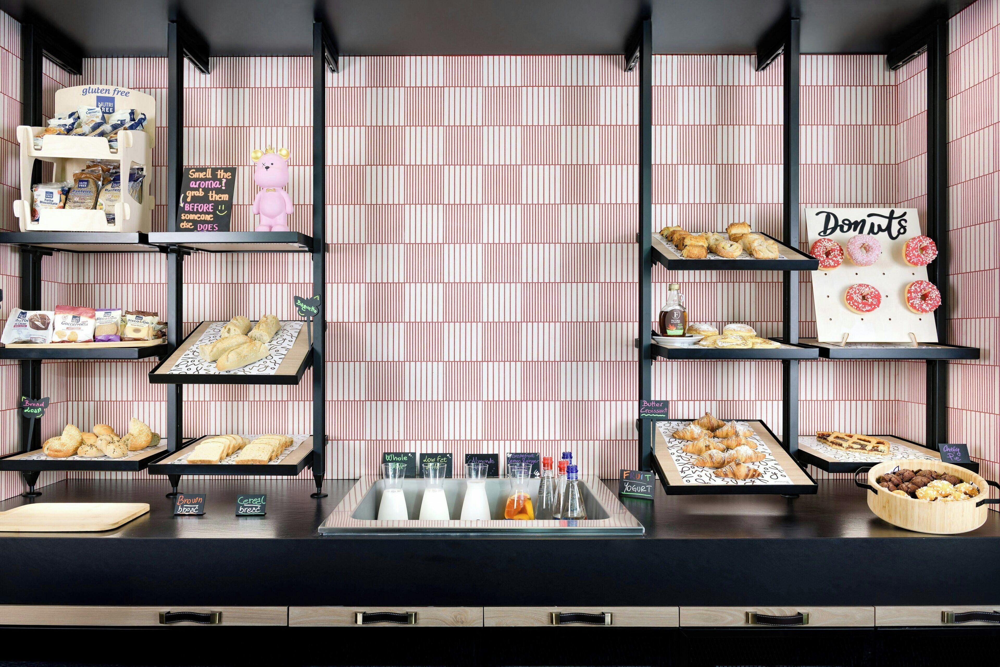 A bakery display with various baked goods and a sign indicating gluten-free options.