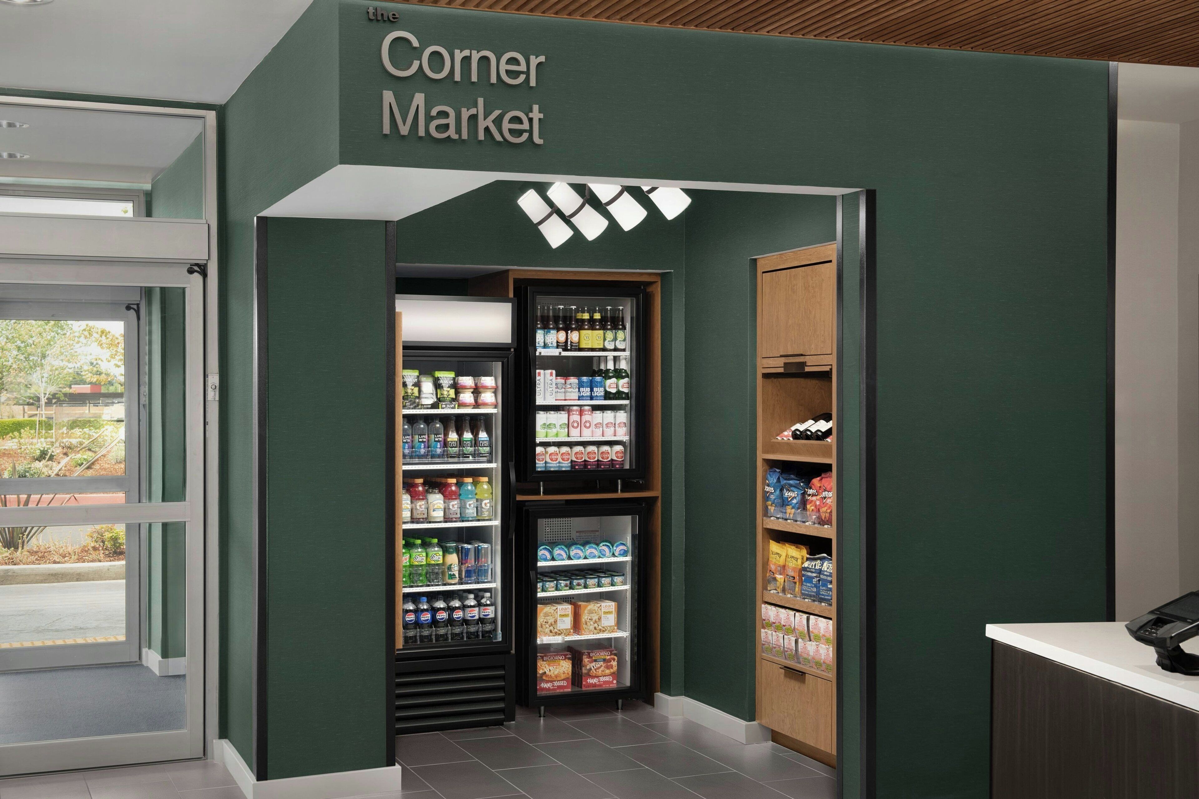 A grocery store with a green wall and a sign that reads "the Corner Market".