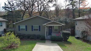 A single-story house with a front porch, a small front yard, and a mailbox. - Cute 3 bedroom, 1 bath home less than 5 minutes from downtown. (Hot Springs)