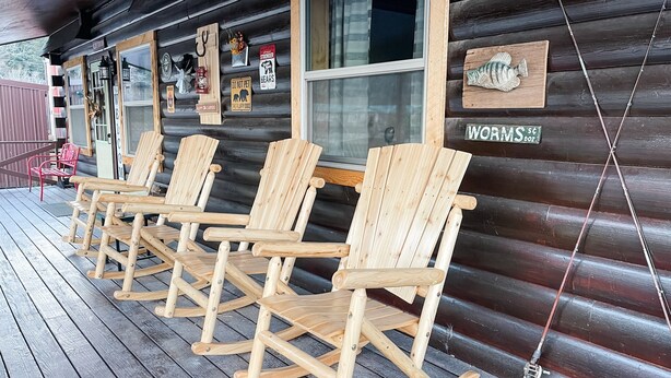 A wooden cabin with a porch featuring four rocking chairs and a sign reading "Worms." - Perfect Family Cabin! 3 Master Suites, Sleeps 10, next to the park! (South Fork)