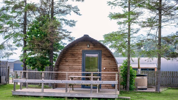 A wooden cabin with a porch and a door. - Rural Cabin With Hot Tub & Accessible Facilities (Kinloss)