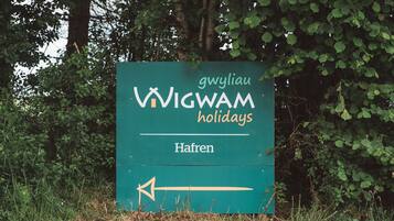 A sign for 'VIGWAM holidays' with a directional arrow pointing left.