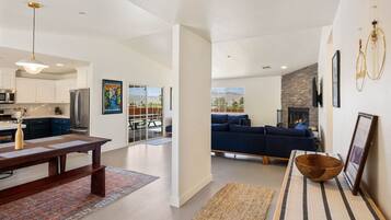 A modern interior with a kitchen, dining area, and living room.