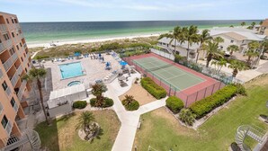 A resort with a pool, tennis court, and beach view. - Reef Club 209 - Oceanview Retreat w/ Pool, Tennis & Sunset Balcony (Indian Rocks Beach)
