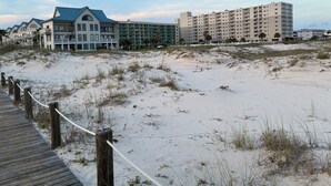 A beachside hotel with multiple buildings, including a large hotel and smaller structures with balconies. - Welcome to SEA-Nanigans. Unit #1366. 
A charming condo with Gulf Views. (Gulf Shores)