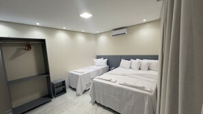 Deluxe Triple Room | Desk, laptop workspace, blackout drapes, iron/ironing board