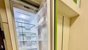 An open refrigerator with multiple shelves and a freezer compartment.