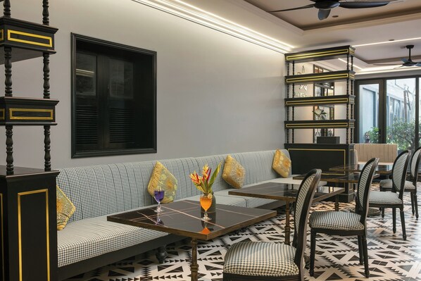 Un intérieur moderne avec un canapé, des tables à manger et des chaises.