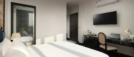 A hotel room with a bed, desk, chair, TV, and air conditioning unit.